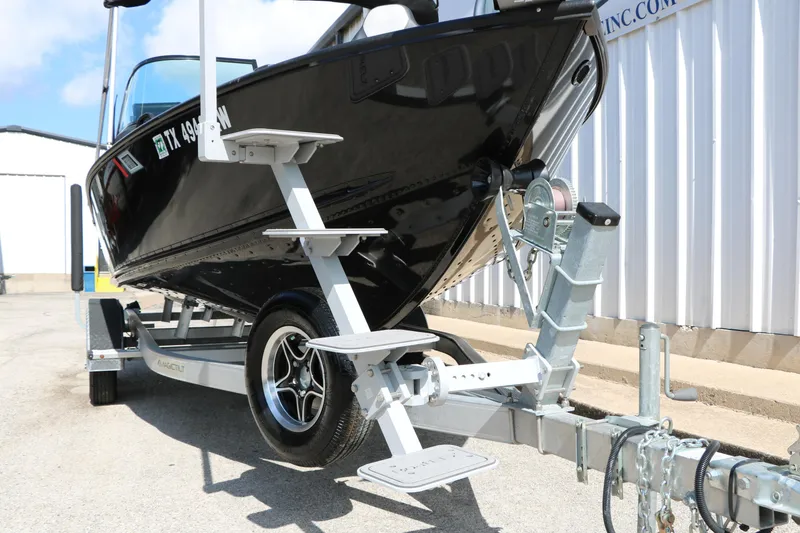 Slide: The Image of 2023 Alumacraft Competitor FSX 185 boat on trailer, parked outdoors. - 15