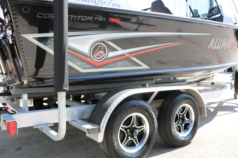 Slide: The Image of 2023 Alumacraft Competitor FSX 185 boat on trailer, showcasing sleek design and graphics. - 19
