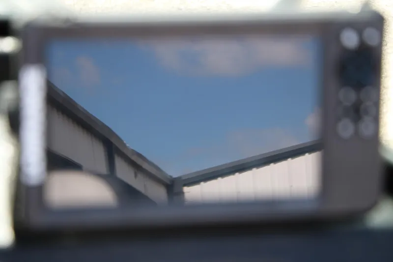 Slide: The Image of Reflection of a building roof on a screen, clear blue sky background. - 35