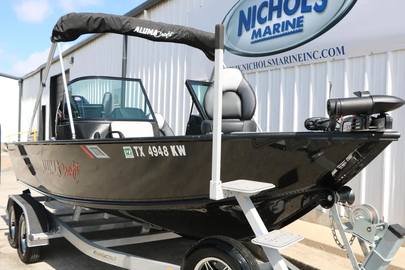 Slide: The Image of 2023 Alumacraft Competitor FSX 185 boat on trailer at Nichols Marine dealership. - 3