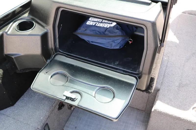 Slide: The Image of 2023 Alumacraft Competitor FSX 185 boat storage compartment with cup holders and gear bag. - 47