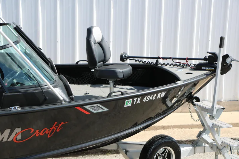 Slide: The Image of 2023 Alumacraft Competitor FSX 185 boat on trailer, featuring a Minn Kota trolling motor. - 11