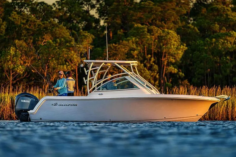 Slide: The Image of Manufacturer Provided Image: 2026 Sailfish 245 DC boat on water, people fishing, lush green background. - 1