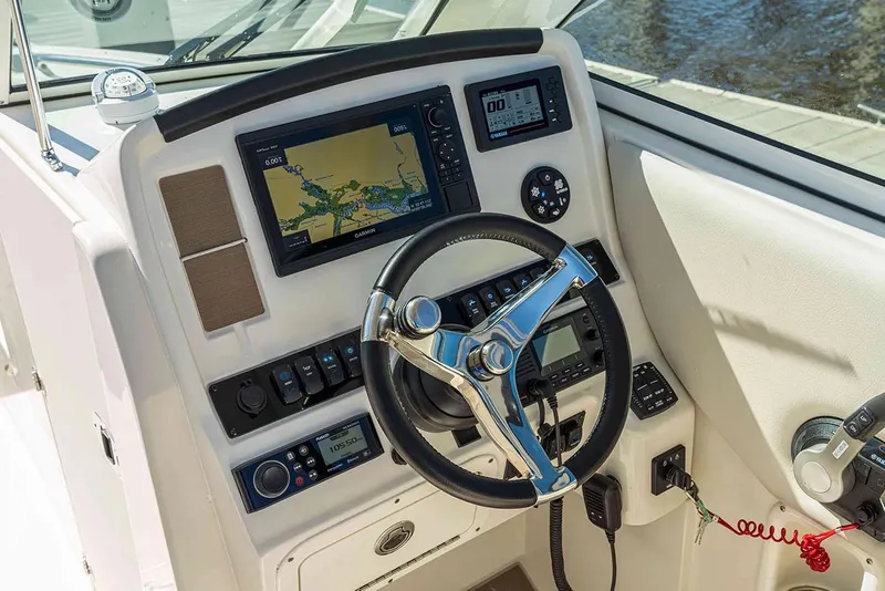 Slide: The Image of Manufacturer Provided Image: 2026 Sailfish 245 DC boat dashboard with steering wheel, navigation system, and control panel. - 5