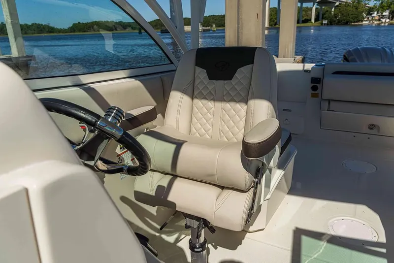 Slide: The Image of Manufacturer Provided Image: 2026 Sailfish 245 DC boat interior with luxurious captain's chair and steering wheel. - 4