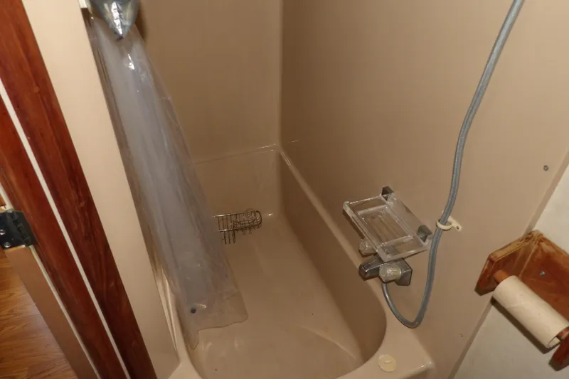 Slide: The Image of Shower area in 1984 Chris-Craft 381 Catalina boat, featuring beige walls and fixtures. - 34