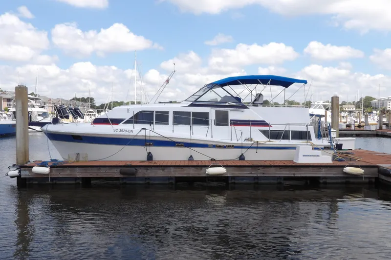 Slide: The Image of 1984 Chris-Craft 381 Catalina yacht docked at marina under blue sky. - 8