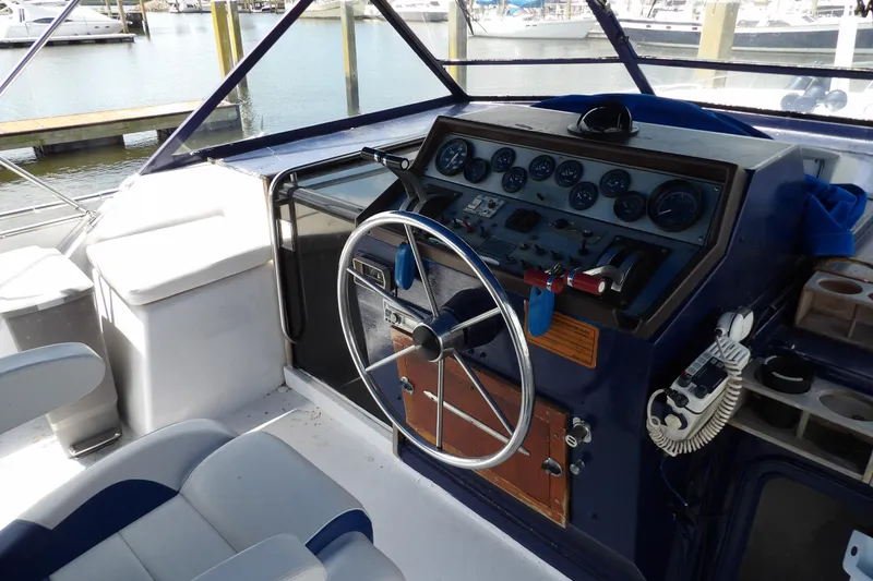 Slide: The Image of 1984 Chris-Craft 381 Catalina helm with steering wheel and control panel at marina. - 12