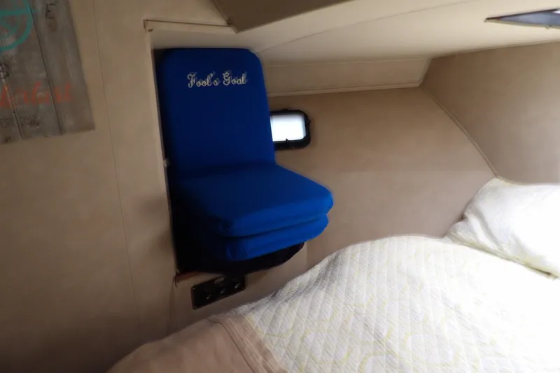 Slide: The Image of Interior cabin of 1984 Chris-Craft 381 Catalina with blue seat and bed. - 22