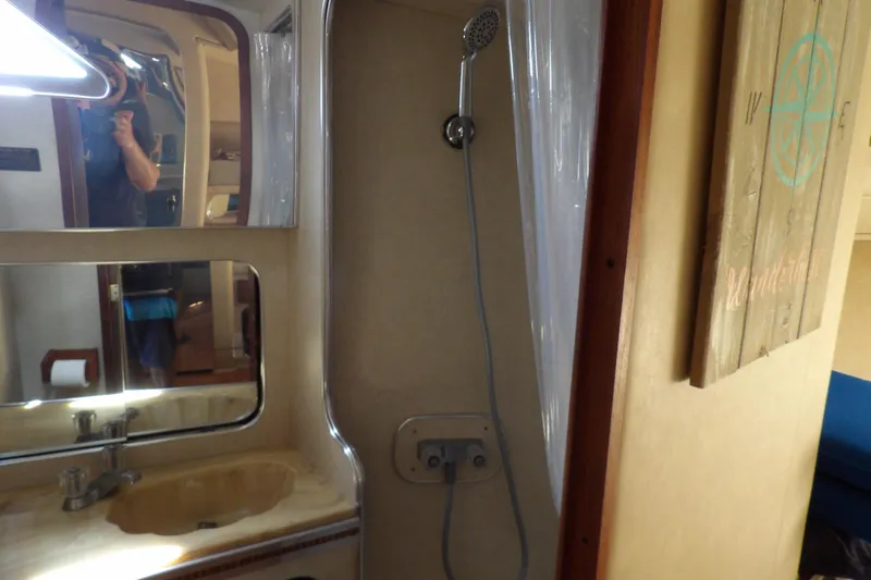 Slide: The Image of 1984 Chris-Craft 381 Catalina bathroom with shower, sink, and mirror. - 36