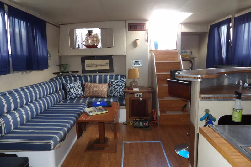 Slide: The Image of Interior of 1984 Chris-Craft 381 Catalina yacht with striped seating and wooden accents. - 26