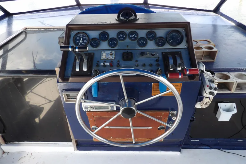 Slide: The Image of 1984 Chris-Craft 381 Catalina helm with gauges, steering wheel, and controls. - 13