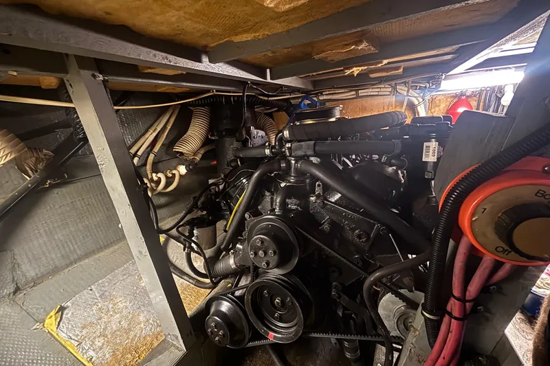 Slide: The Image of Engine room of 1984 Chris-Craft 381 Catalina, showcasing mechanical components and wiring. - 44