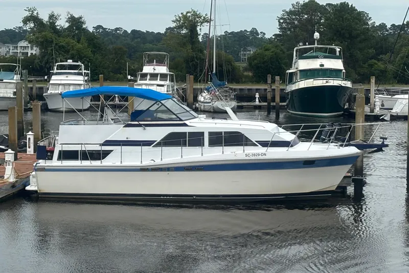 Slide: The Image of 1984 Chris-Craft 381 Catalina yacht docked at marina with blue canopy. - 3