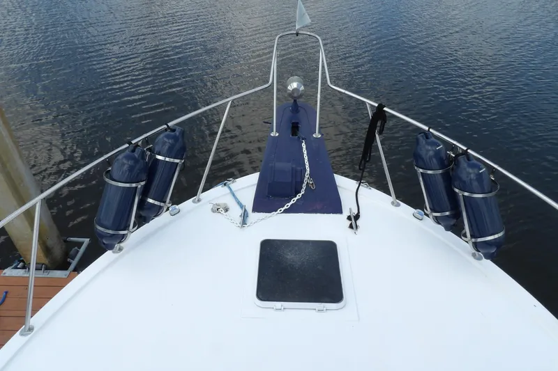 Slide: The Image of 1984 Chris-Craft 381 Catalina boat bow with fenders and anchor chain on calm water. - 10