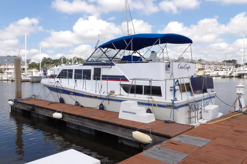Slide: The Image of 1984 Chris-Craft 381 Catalina yacht docked at marina under blue sky. - 2