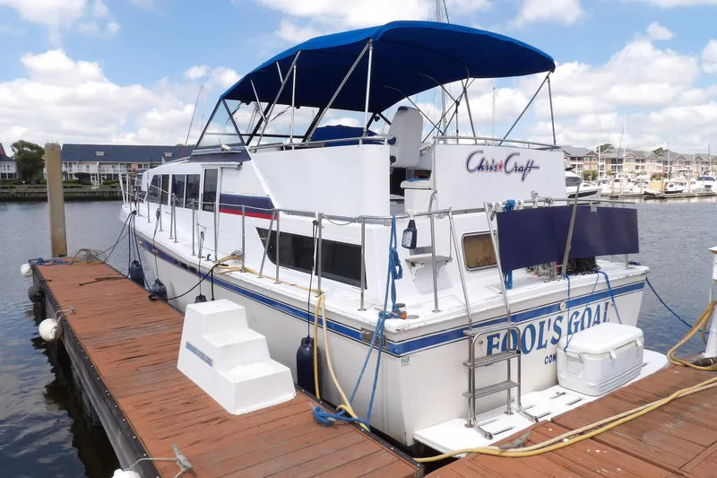 Slide: The Image of 1984 Chris-Craft 381 Catalina docked, featuring blue canopy and classic design. - 7