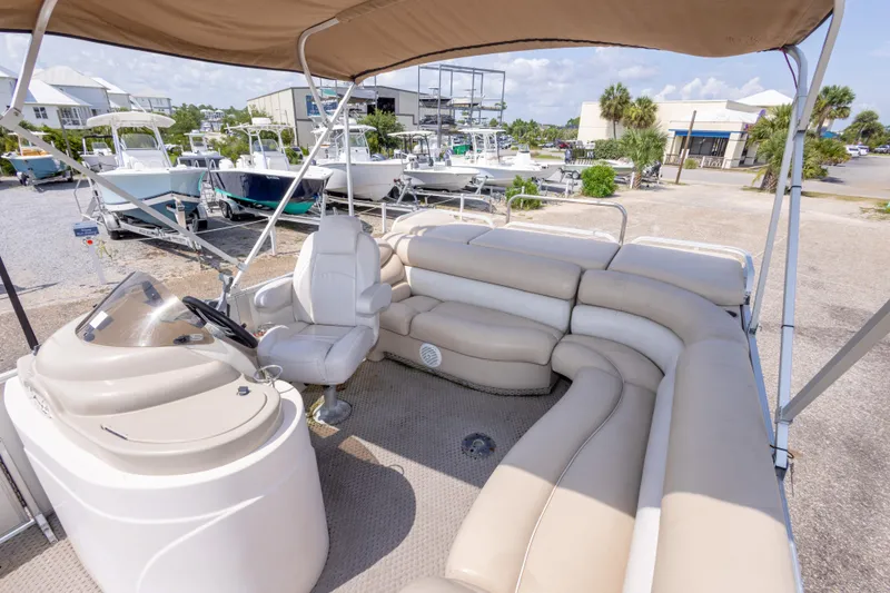 Slide: The Image of 2007 Crest 111 XRS pontoon boat with beige seating and canopy in a marina setting. - 21