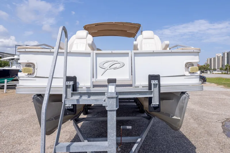 Slide: The Image of 2007 Crest 111 XRS pontoon boat on trailer, sunny day, marina background. - 15