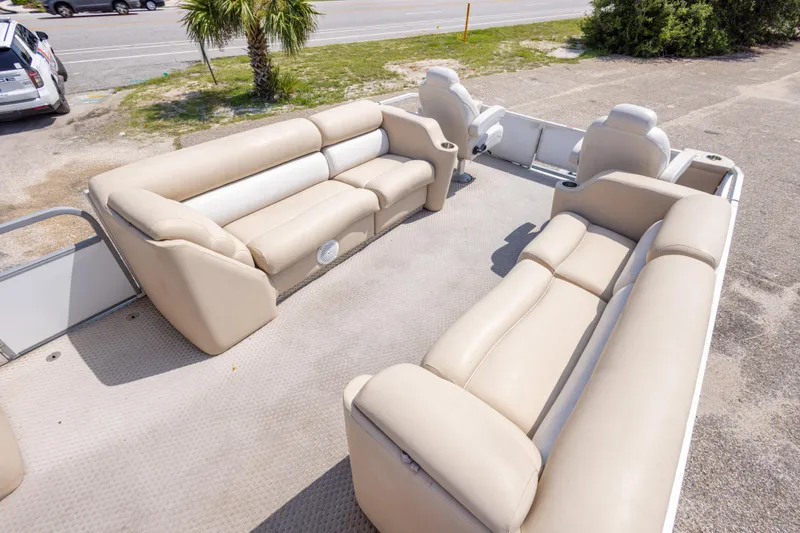 Slide: The Image of 2007 Crest 111 XRS pontoon boat with beige seating, parked near a road and palm tree. - 29