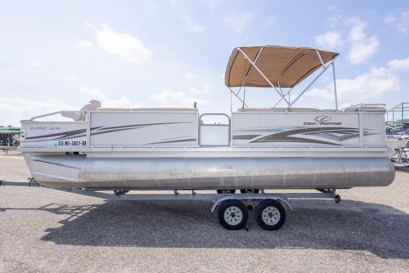 Slide: The Image of 2007 Crest 111 XRS pontoon boat with canopy on a trailer, side view. - 13