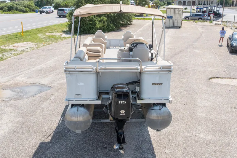 Slide: The Image of 2007 Crest 111 XRS pontoon boat with canopy, parked on a paved lot. - 34