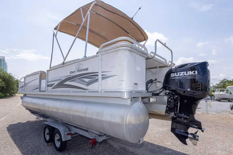 Slide: The Image of 2007 Crest 111 XRS pontoon boat with Suzuki outboard motor on trailer. - 12