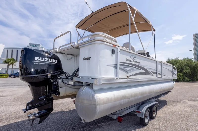 Slide: The Image of 2007 Crest 111 XRS pontoon boat with Suzuki outboard motor on trailer. - 10