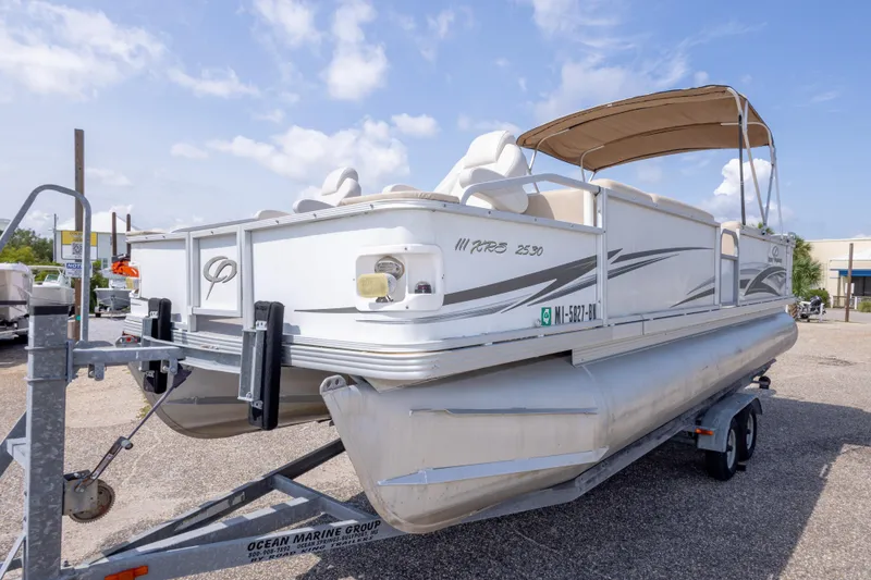 Slide: The Image of 2007 Crest 111 XRS pontoon boat on trailer under blue sky. - 14