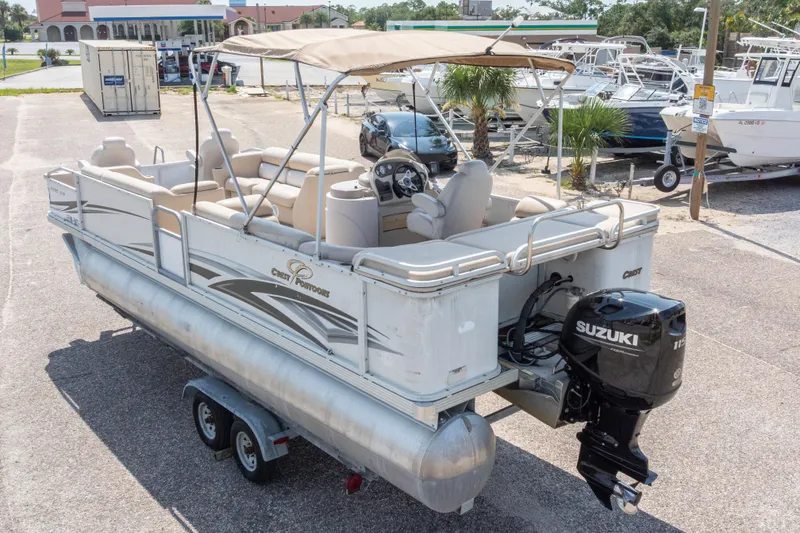 Slide: The Image of 2007 Crest 111 XRS pontoon boat with Suzuki outboard motor in a marina setting. - 35