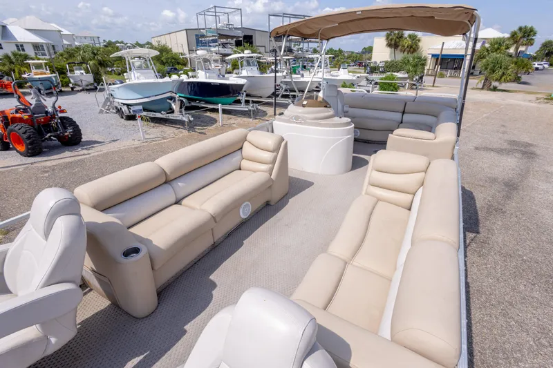 Slide: The Image of 2007 Crest 111 XRS pontoon boat with beige seating and canopy in a marina. - 18