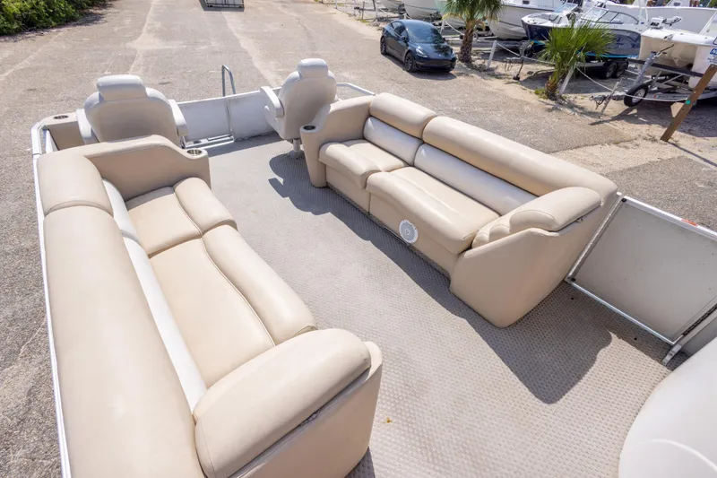 Slide: The Image of 2007 Crest 111 XRS pontoon boat with spacious beige seating and open deck layout. - 28