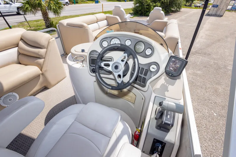Slide: The Image of Interior of a 2007 Crest 111 XRS boat with steering wheel and dashboard controls. - 25