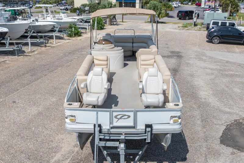 Slide: The Image of 2007 Crest 111 XRS pontoon boat with beige seating, parked in a marina. - 36