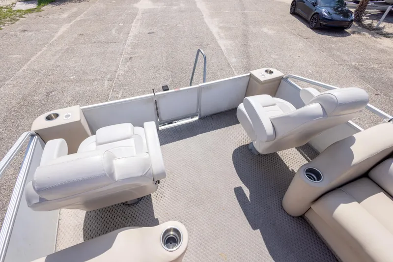 Slide: The Image of 2007 Crest 111 XRS boat interior with beige seating and cup holders. - 31
