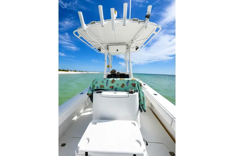 Slide: The Image of 2015 Yellowfin 26 Hybrid boat on clear water under blue sky. - 15