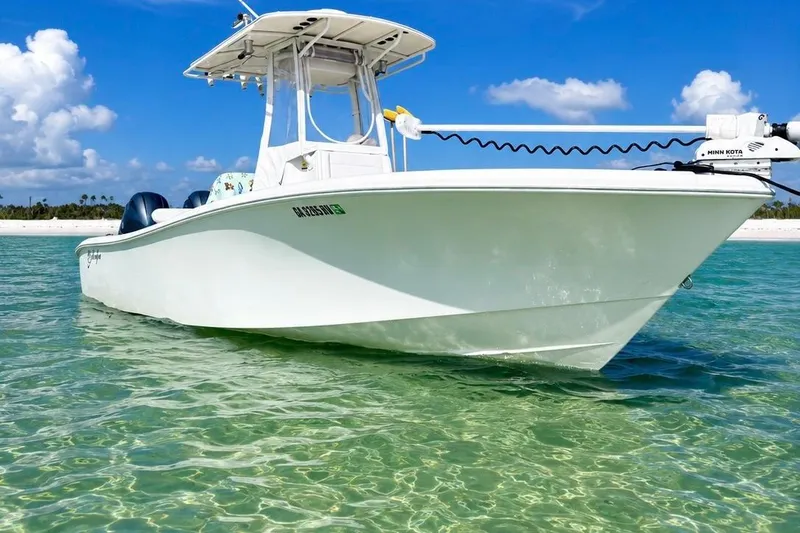 Slide: The Image of 2015 Yellowfin 26 Hybrid boat on clear turquoise water under blue sky. - 1