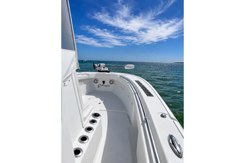 Slide: The Image of 2015 Yellowfin 26 Hybrid boat on open water under a clear blue sky. - 8