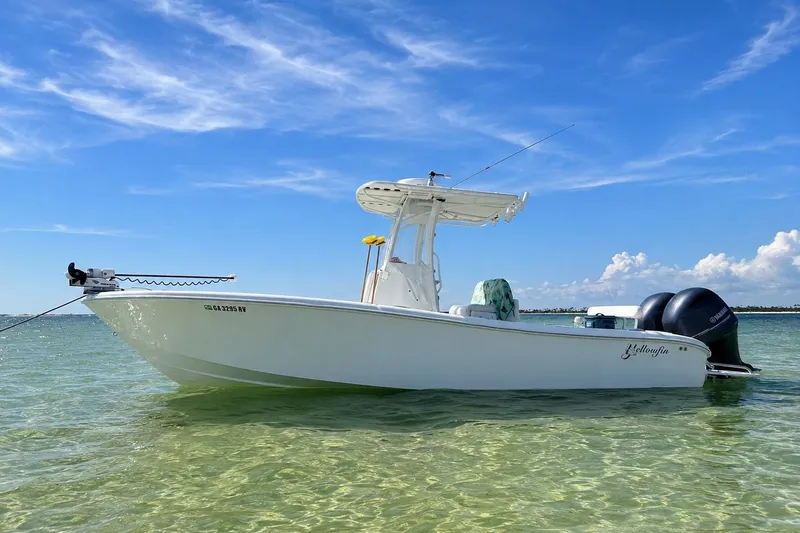 Slide: The Image of 2015 Yellowfin 26 Hybrid boat on clear water under a blue sky. - 3