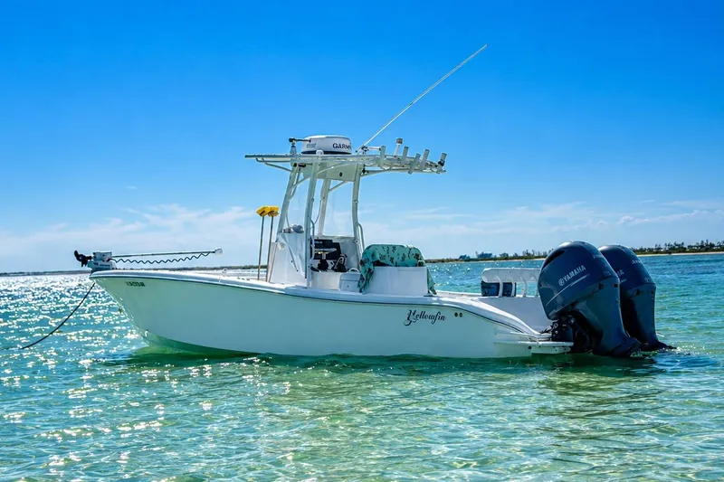 Slide: The Image of 2015 Yellowfin 26 Hybrid boat on clear blue water, featuring dual Yamaha engines. - 4