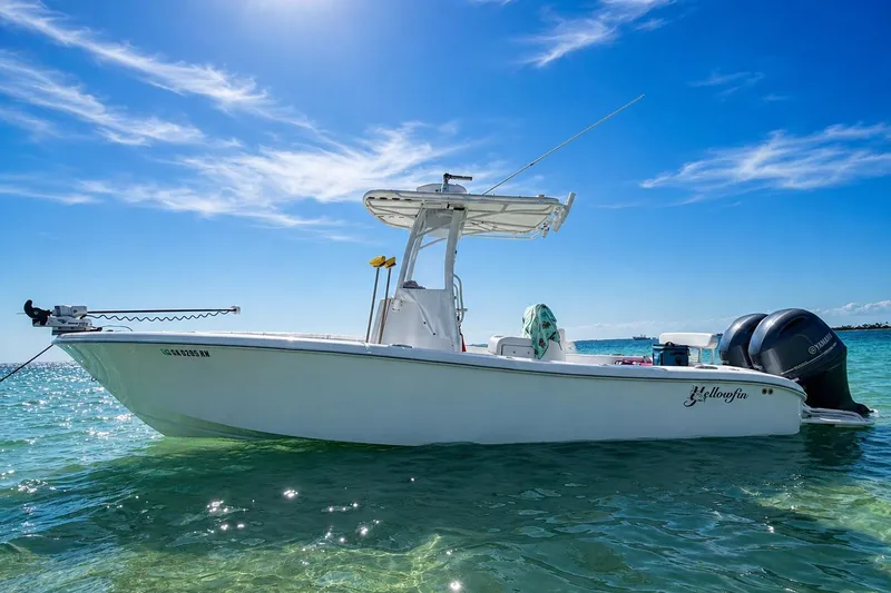 Slide: The Image of 2015 Yellowfin 26 Hybrid boat on clear blue water under sunny sky. - 2