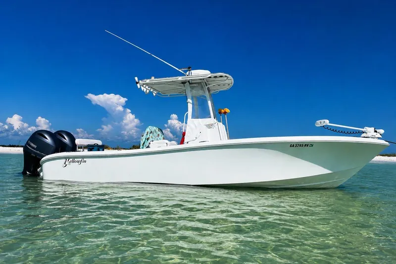 Slide: The Image of 2015 Yellowfin 26 Hybrid boat on clear water under blue sky. - 0