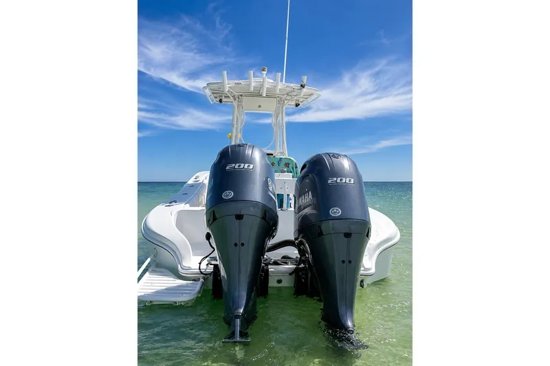 Slide: The Image of 2015 Yellowfin 26 Hybrid boat with dual Yamaha 200 engines on clear water. - 6