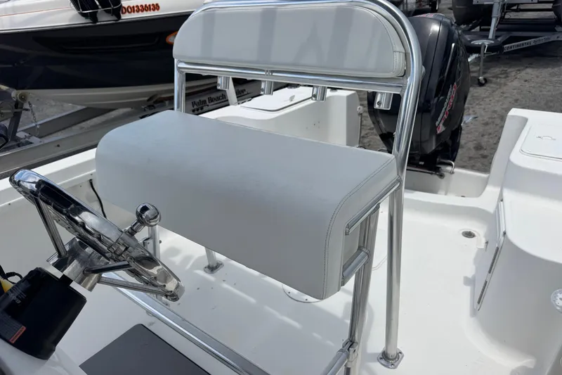 Slide: The Image of 2004 Sea Fox 225 Bay Fisher boat interior with steering wheel and seating. - 16