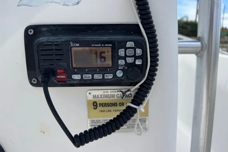 Slide: The Image of VHF marine radio on 2004 Sea Fox 225 Bay Fisher, showing channel 16 and capacity label. - 11