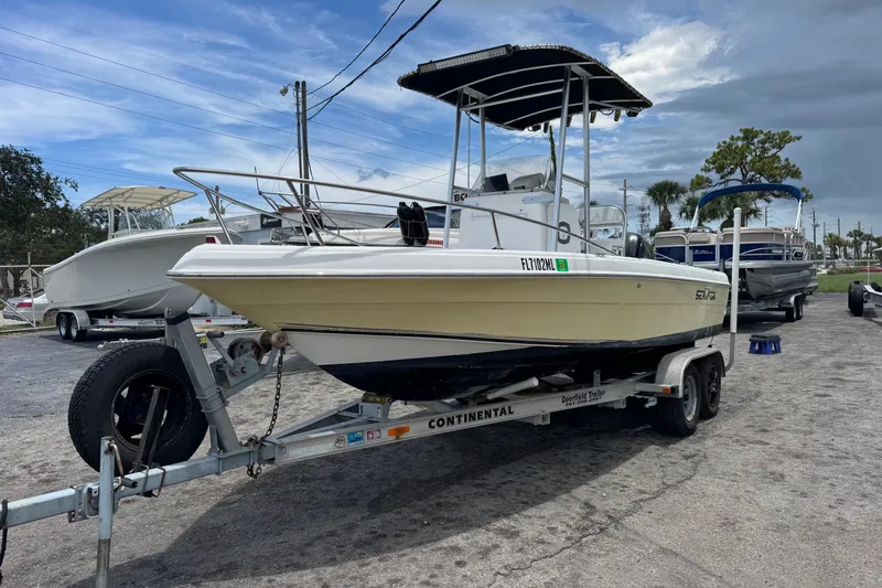 Slide: The Image of 2004 Sea Fox 225 Bay Fisher boat on trailer, parked outdoors under cloudy sky. - 3