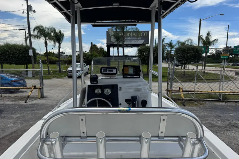 Slide: The Image of 2004 Sea Fox 225 Bay Fisher boat with T-top and console, parked outdoors. - 5