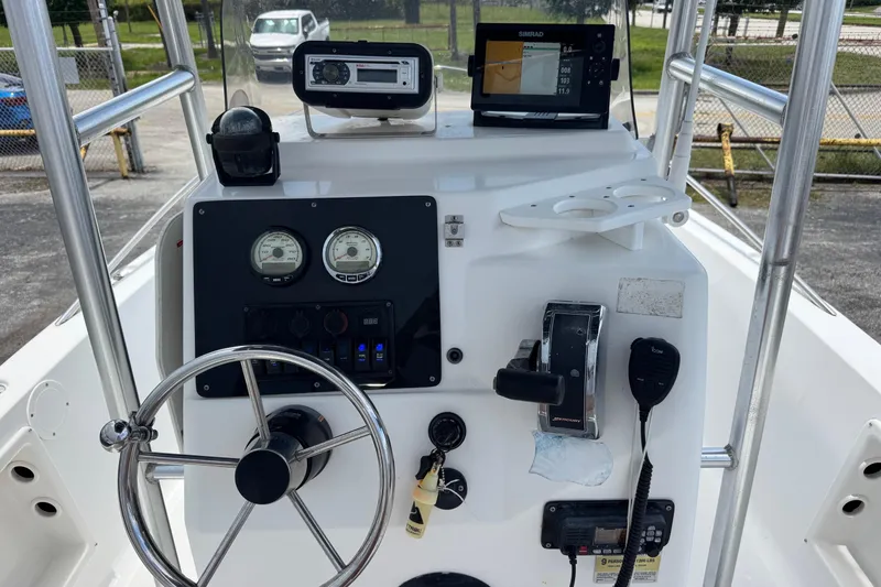 Slide: The Image of Console of a 2004 Sea Fox 225 Bay Fisher boat with steering wheel and gauges. - 6