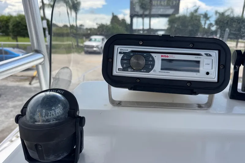 Slide: The Image of Compass and audio system on 2004 Sea Fox 225 Bay Fisher boat dashboard. - 8