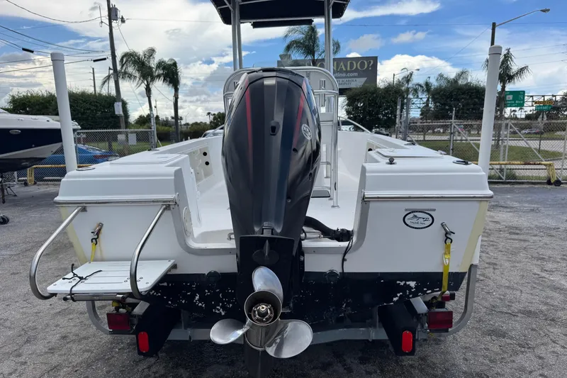 Slide: The Image of 2004 Sea Fox 225 Bay Fisher boat with outboard motor, parked outdoors. - 34